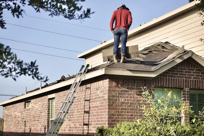 Professional roofer working on a residential roof in Cedar Crest